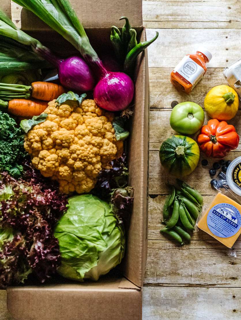A Harvie box filled with fresh vegetables and local groceries